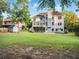 Large backyard with a spacious lawn, wooden deck, lower covered patio, and mature trees at 358 Woodbrook Crst, Canton, GA 30114