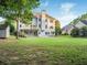 Expansive backyard features a lush lawn, established trees, plus a wooden deck and covered patio at 358 Woodbrook Crst, Canton, GA 30114