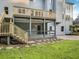 Backyard view features a wooden deck, a covered patio below, stairs, and a lush lawn at 358 Woodbrook Crst, Canton, GA 30114