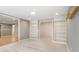 Finished basement with carpet floors, recessed lighting, and arched doorways to unfinished storage space at 358 Woodbrook Crst, Canton, GA 30114