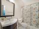 Bathroom features a vanity with a black cabinet and patterned shower curtain at 358 Woodbrook Crst, Canton, GA 30114