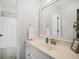 Bright bathroom featuring a bathtub and a white vanity with a decorative mirror at 358 Woodbrook Crst, Canton, GA 30114