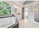 Bright bathroom featuring a corner soaking tub and a double vanity at 358 Woodbrook Crst, Canton, GA 30114