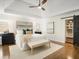 Bright bedroom with a tray ceiling, ceiling fan, and walk-in closet with barn door at 358 Woodbrook Crst, Canton, GA 30114