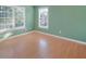 Bedroom with light-green painted walls, blinds, and hardwood floors at 358 Woodbrook Crst, Canton, GA 30114