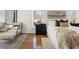 Cozy bedroom showcasing hardwood floors, stylish rug, seating, and decor at 358 Woodbrook Crst, Canton, GA 30114