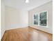 Bright bedroom featuring wood floors and a large window overlooking backyard at 358 Woodbrook Crst, Canton, GA 30114