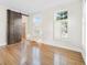 Bedroom with hardwood floors, barn door and bright natural light at 358 Woodbrook Crst, Canton, GA 30114