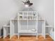 Custom closet with built-in shelving, clothing rods, and a ceiling fan at 358 Woodbrook Crst, Canton, GA 30114