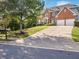 Exterior features a long concrete driveway that leads to the two-car garage at 358 Woodbrook Crst, Canton, GA 30114