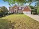 Traditional brick home with an expansive lawn and symmetrical facade at 358 Woodbrook Crst, Canton, GA 30114