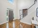 Bright foyer with hardwood floors, a staircase, and a modern front door at 358 Woodbrook Crst, Canton, GA 30114