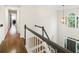 View of second story hallway with staircase and contemporary light fixture at 358 Woodbrook Crst, Canton, GA 30114