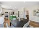 Open-concept kitchen and dining area with stainless steel appliances and a green kitchen island at 358 Woodbrook Crst, Canton, GA 30114