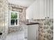 Laundry room with charming wallpaper and convenient countertop space at 358 Woodbrook Crst, Canton, GA 30114