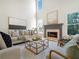 Cozy living room with a fireplace, flooded with natural light from the large windows at 358 Woodbrook Crst, Canton, GA 30114