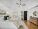 Bright main bedroom with tray ceilings, hardwood floors, a ceiling fan, and a large closet at 358 Woodbrook Crst, Canton, GA 30114