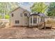 Spacious backyard features wood deck, neutral siding, and lots of mature trees at 3614 Spring Leaf Ln, Acworth, GA 30101