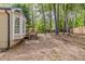 View of the backyard with mature trees, wood deck, and neutral siding at 3614 Spring Leaf Ln, Acworth, GA 30101