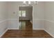 Elegant dining room showcasing wainscoting, modern light fixture, and wood-look flooring, perfect for entertaining guests at 3614 Spring Leaf Ln, Acworth, GA 30101