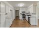 Bright kitchen featuring white cabinets, stainless steel appliances, and hardwood flooring, offering a modern and clean design at 3614 Spring Leaf Ln, Acworth, GA 30101