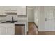 A modern kitchen with stainless steel appliances, dark countertops, a stainless sink and wood look floors at 3614 Spring Leaf Ln, Acworth, GA 30101