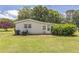 Backyard view of well-maintained, single-story brick home with nice yard at 1035 Cornish Mountain Church Rd, Oxford, GA 30054