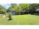 Large backyard featuring a storage structure and green space at 1035 Cornish Mountain Church Rd, Oxford, GA 30054