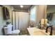 The bathroom has a granite vanity, a shower, a toilet, and updated plumbing fixtures at 1035 Cornish Mountain Church Rd, Oxford, GA 30054