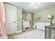Spacious Bedroom with pastel green walls, a gray crib, and changing station at 1035 Cornish Mountain Church Rd, Oxford, GA 30054