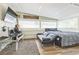 The bedroom has hardwood floors, large windows, a futon couch and a comfortable bed at 1035 Cornish Mountain Church Rd, Oxford, GA 30054