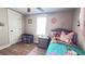 Comfortable bedroom has a window, wooden floors, ceiling fan, and a neutral color palette at 1035 Cornish Mountain Church Rd, Oxford, GA 30054