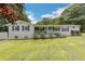 Well-maintained brick home featuring a cozy covered front porch and manicured lawn at 1035 Cornish Mountain Church Rd, Oxford, GA 30054