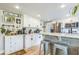 Modern kitchen with white cabinets, stainless steel appliances, and a breakfast bar at 1035 Cornish Mountain Church Rd, Oxford, GA 30054