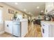 Bright kitchen with white cabinets, stainless steel appliances, and access to the living room at 1035 Cornish Mountain Church Rd, Oxford, GA 30054