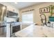 Bright kitchen featuring stainless steel appliances, light countertops and an 
