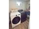 Well-lit laundry room with washer, dryer, shelving, and a convenient window at 1035 Cornish Mountain Church Rd, Oxford, GA 30054