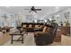 Comfortable living room featuring a large sectional sofa, ceiling fan, and light wood flooring at 1035 Cornish Mountain Church Rd, Oxford, GA 30054