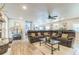 Open living room with a sectional sofa, light wood floors, and easy access to the kitchen at 1035 Cornish Mountain Church Rd, Oxford, GA 30054
