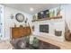 Charming living room featuring a brick fireplace, hardwood floors, and stylish decor at 1035 Cornish Mountain Church Rd, Oxford, GA 30054