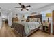 Comfortable main bedroom with a ceiling fan, a large bed, and hardwood floors at 1035 Cornish Mountain Church Rd, Oxford, GA 30054