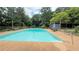 A refreshing in-ground pool with a spacious deck and a dining table for poolside enjoyment at 1035 Cornish Mountain Church Rd, Oxford, GA 30054