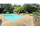 Large in-ground pool surrounded by mature trees and a chain-link fence offering a private oasis at 1035 Cornish Mountain Church Rd, Oxford, GA 30054
