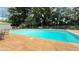 A sparkling in-ground pool surrounded by a concrete deck and a chain-link fence at 1035 Cornish Mountain Church Rd, Oxford, GA 30054