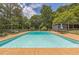 Large in-ground pool with an expansive deck area and chain-link fence, perfect for summer fun at 1035 Cornish Mountain Church Rd, Oxford, GA 30054