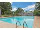 Beautiful in-ground pool with mature trees, string lights, and outdoor seating perfect for entertaining at 1035 Cornish Mountain Church Rd, Oxford, GA 30054