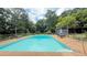 A sparkling in-ground pool surrounded by a concrete deck and a chain-link fence at 1035 Cornish Mountain Church Rd, Oxford, GA 30054