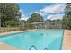 Spacious in-ground pool with mature trees, string lights and ample decking for outdoor enjoyment at 1035 Cornish Mountain Church Rd, Oxford, GA 30054