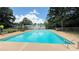 Large in-ground pool with clear blue water, fenced for safety with a patio area at 1035 Cornish Mountain Church Rd, Oxford, GA 30054