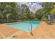 Refreshing in-ground pool featuring a ladder and a deck area with ample space for entertaining guests at 1035 Cornish Mountain Church Rd, Oxford, GA 30054